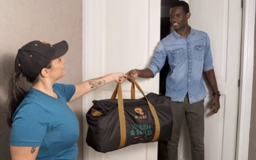A Rinse Valet delivering a wash and fold bag